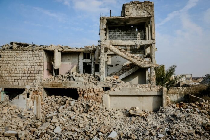 Rubble and ruins of a destroyed building in Idlib, Syria, showcasing the devastation of war.