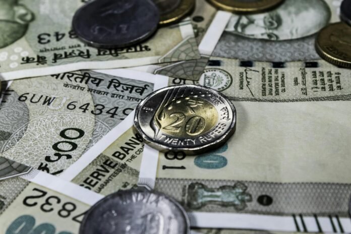 Indian rupee currency notes and coins representing income tax filing