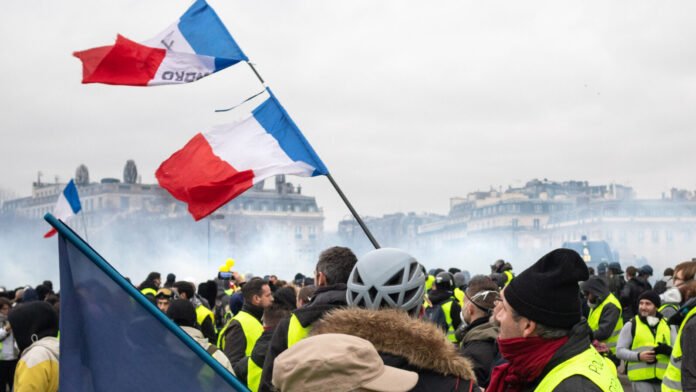Yellow Vest demonstrators carrying French flags in Paris in January 2019