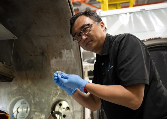 SPEARS — Solid Power with Extreme Environment Adaptability and Resilience in Space NASA researcher Yi Lin holding a small SPEARS battery after thermal vacuum tests