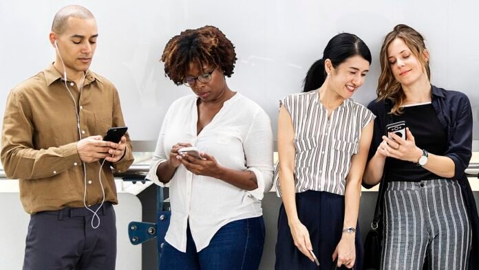Representative photograph of people using smartphones, not a UPI payment Representative photograph of people using smartphones, not a UPI payment