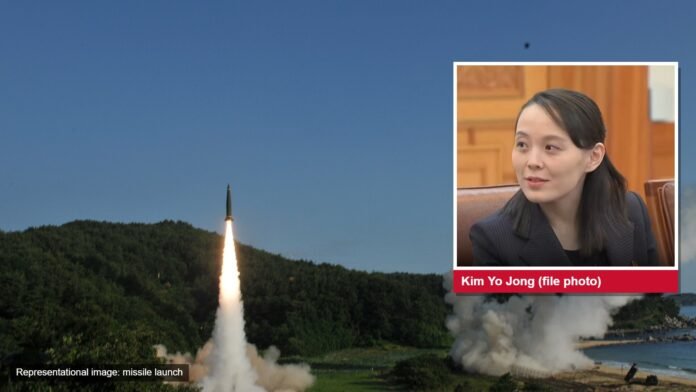 A missile lifting off from a wooded coast, with an inset portrait of Kim Yo Jong