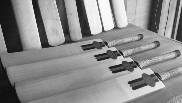 Handmade cricket bats on a bat maker’s bench