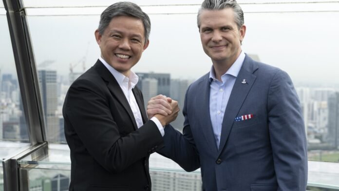 Chan Chun Sing and Pete Hegseth shake hands in Singapore in a May 2025 file photograph
