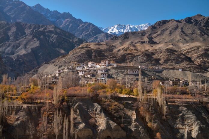 Charming village nestled in rugged mountains of Ladakh with stunning landscape views.